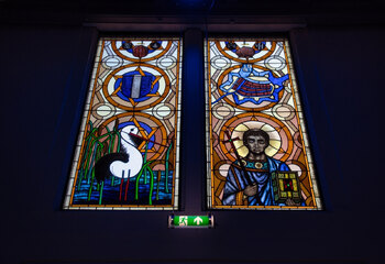 Colorful stained glass windows above the church entrance